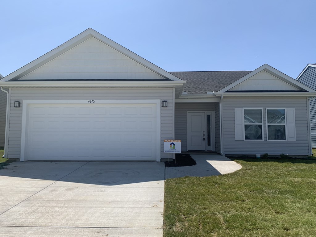 a white house with a driveway and a garage door